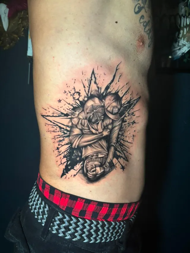 Trash polka rib tattoo of two brothers embracing