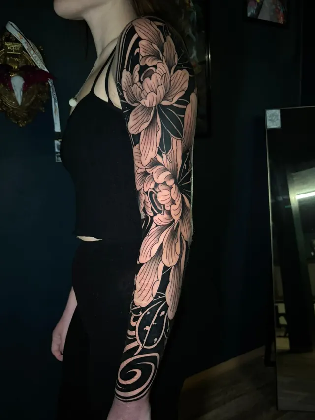 Ornamental blackwork peony full-sleeve tattoo