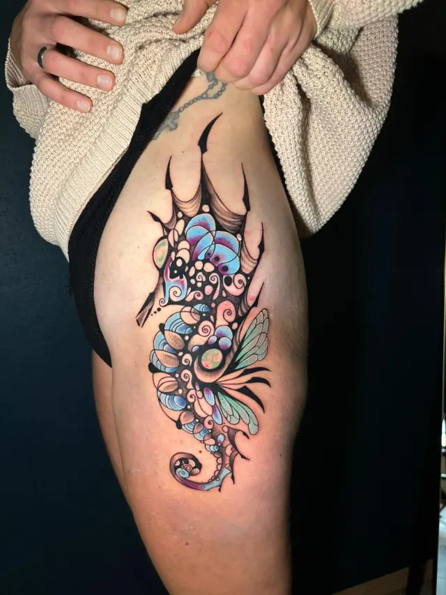 Neo-traditional colour seahorse tattoo on the thigh